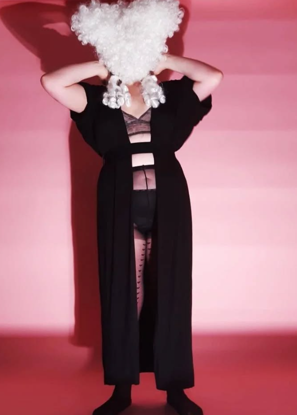 Fredde artistic portrait with white fluffy headpiece